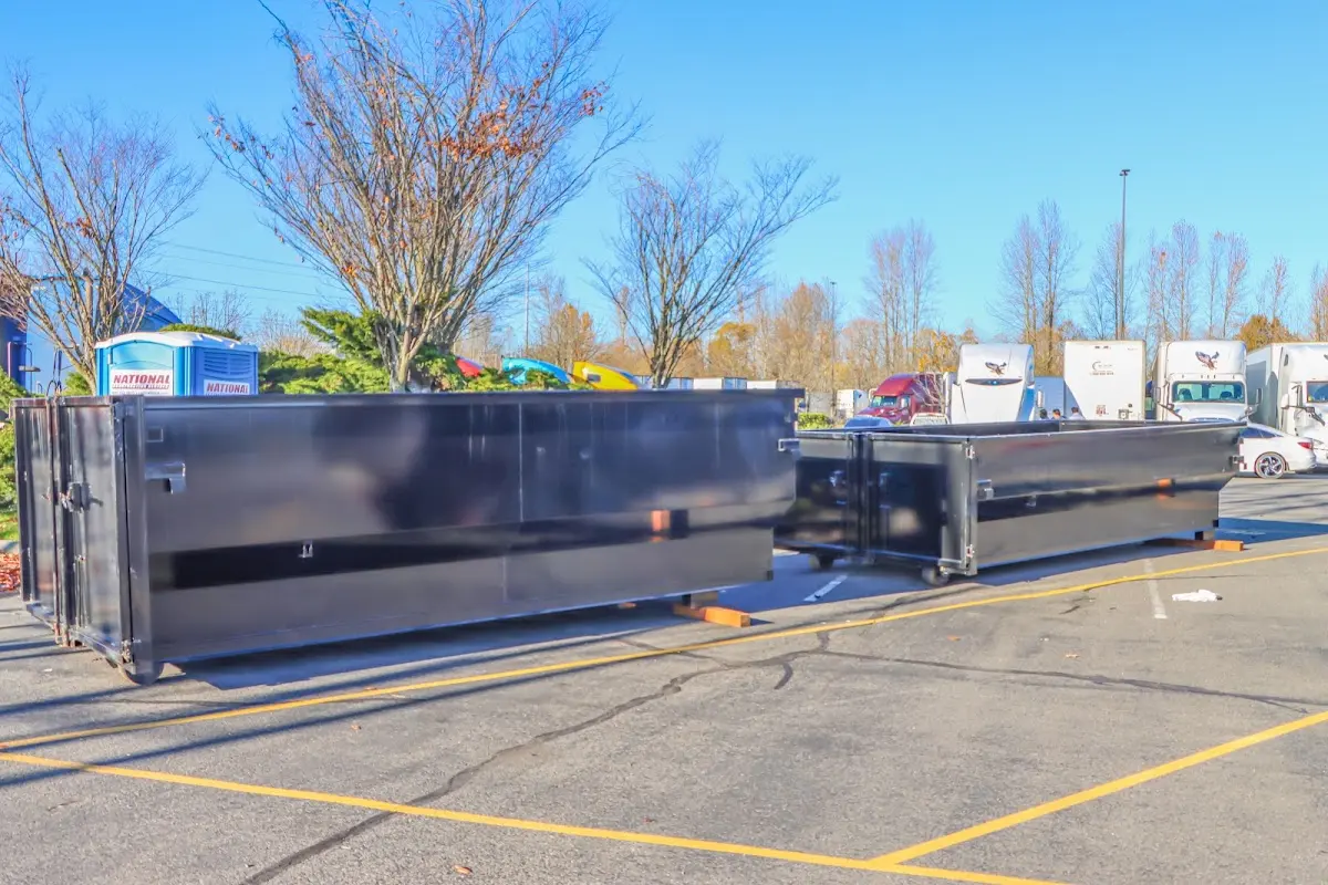 Professional dumpster rental service with roll-off container on residential driveway in Taylor